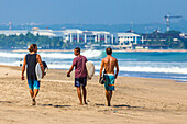 Surfers on a beach, Bali, Indonesia.