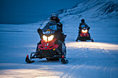 UNIS students practice driving snowmobiles through Adventdalen, Svalbard as part of their basic safety training.