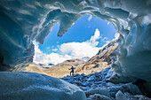 Hiker inside Forni Glacier, Forni Valley, Stelvio National Park, Valtellina, Lombardy, Italy, Europe