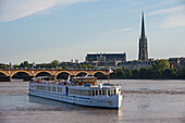 Cruise sailing in front of the skyline of Bordeaux, Aquitaine, France, Europe