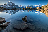 Snowy peaks of Aiguilles Verte, Dent Du Geant, and Mont Blanc are reflected in Lac Blanc, Haute Savoie, French Alps, France, Europe