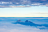 Volcanoes of Illiniza Norte, 5126m on left and Illiniza Sur, 5248m on right, seen from Cotopaxi Volcano 5897m summit, Cotopaxi Province, Ecuador, South America