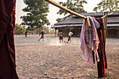 Novice monks playing football at a Buddhist Monastery between Inle Lake and Kalaw, Shan State, Myanmar Burma, Asia