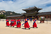 Marching band in bright traditional dress, colourful Changing of the Guard Ceremony, Gyeongbokgung Palace, Seoul, South Korea, Asia