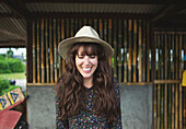 Smiling Caucasian woman wearing sun hat outdoors