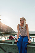 Caucasian woman sitting on bridge