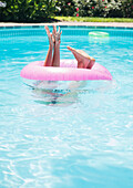 Caucasian woman playing in swimming pool