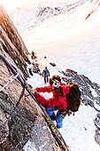 Mountain Guide climbing down the metal steps, morning light, Oberaarjoch hut, Wallis, Switzerland