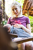 Women breastfeeding her baby in her arms, infant, Boipeba, Bahia, Brasil