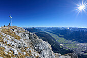 Several persons sitting at summit of Hohe Munde, view towards valley of Inn, view from Hohe Munde, Hohe Munde, Mieming Range, Tyrol, Austria