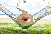 Girl resting on hammock by Balsam Lake, Ontario, Canada