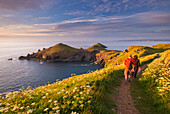 Walkers on the South West Coast Path on Pentire Head, overlooking The Rumps, Cornwall, England, United Kingdom, Europe