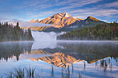 Pyramid Mountain reflected in Pyramid Lake at dawn on a misty morning, Jasper National Park, UNESCO World Heritage Site, Alberta, Canada, North America