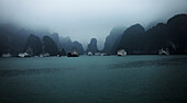 Boats at Halong bay against sky, Vietnam