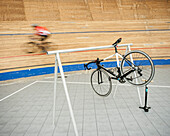 Bicycle hanging on rack at sports track
