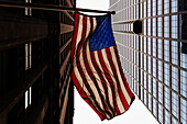 Low angle view of American flag and office buildings