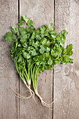 Directly above shot of coriander leaves on wooden table