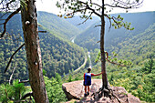 Woman backpacker hiking on the West Rim Trail in Tioga State Park of north central Pennsylvania September 2011. The 30-mile long trail overlooks Pine Creek Gorge and is considered the Grand Canyon of Pennsylvania.