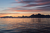 Evening light over mountains and icy water near Tasiilaq, east Greenland