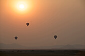 Hot air balloons rise at sunrise in Sossusvlei, Namibia