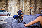 Man on motorcycle with surfboard at Bali.