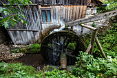 Mill wheel and waterway at dilapidated building
