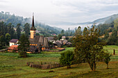 Church in misty rural valley