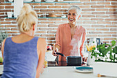 Women talking in kitchen