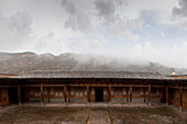 Remote monastery and cloudy sky, Qinghai, Tibet, China