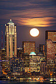 Moon and high rise buildings over Seattle waterfront, Washington, United States
