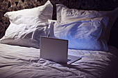 Laptop computer on bed