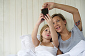 Mother and daughter posing for selfie