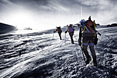 roped mountain climbers braving the harsh conditions to reach the summit of the gran paradiso mountain, vittorio-emanuele ii refuge, valsavarenche, val d'aoste, italy