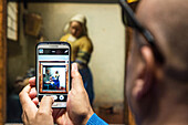 taking a photo of the milkmaid with a smartphone, painting by johannes vermeer, rijksmuseum, amsterdam, holland