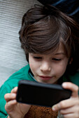 Boy playing with mobile phone