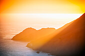 Scenic view of sea and mountain during sunset