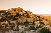 Hilltop village of Gordes with castle and church at sunrise, Provence, Provence-Alpes-Cote d'Azur, France, Europe