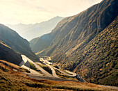 Cyclist on a winding mountain pass, Italy, Europe