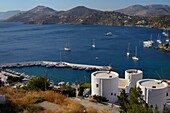 Old windmills, restored as holiday accommodation above Panteli harbour, Leros, Dodecanese Islands, Greek Islands, Greece, Europe
