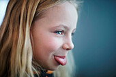 Caucasian girl sticking out tongue