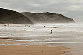 View of people on a beach and cliffs, Praia da Arrifana, Portugal beach