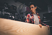 A carpenter works at his trade in his shop.