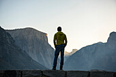 Man looking at Yosemite Valley at sunrise. CA, USA.
