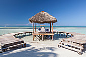 Wooden jetty entering turquoise water with no people in Cayo Guillermo, Cuba