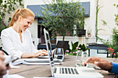 Businesswoman working with colleagues at outdoor meeting
