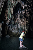 Thai man punting through Tham Lot cave, Thailand, Southeast Asia