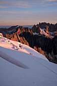 Morning dawn ascending the Barre des Ecrins with views of the Meije, Ecrins National Park, Dauphiné, France