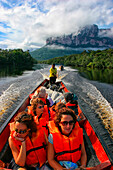 A dugout canoe carrying tourists speeds along the Canaima River towards Angel Falls, in Canaima National Park, Venezuela