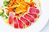 High angle view of sliced tuna and salad