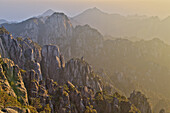 View of mountain range with granite peaks at sunrise, Huangshan (Yellow Mountains), Anhui Province, China, October